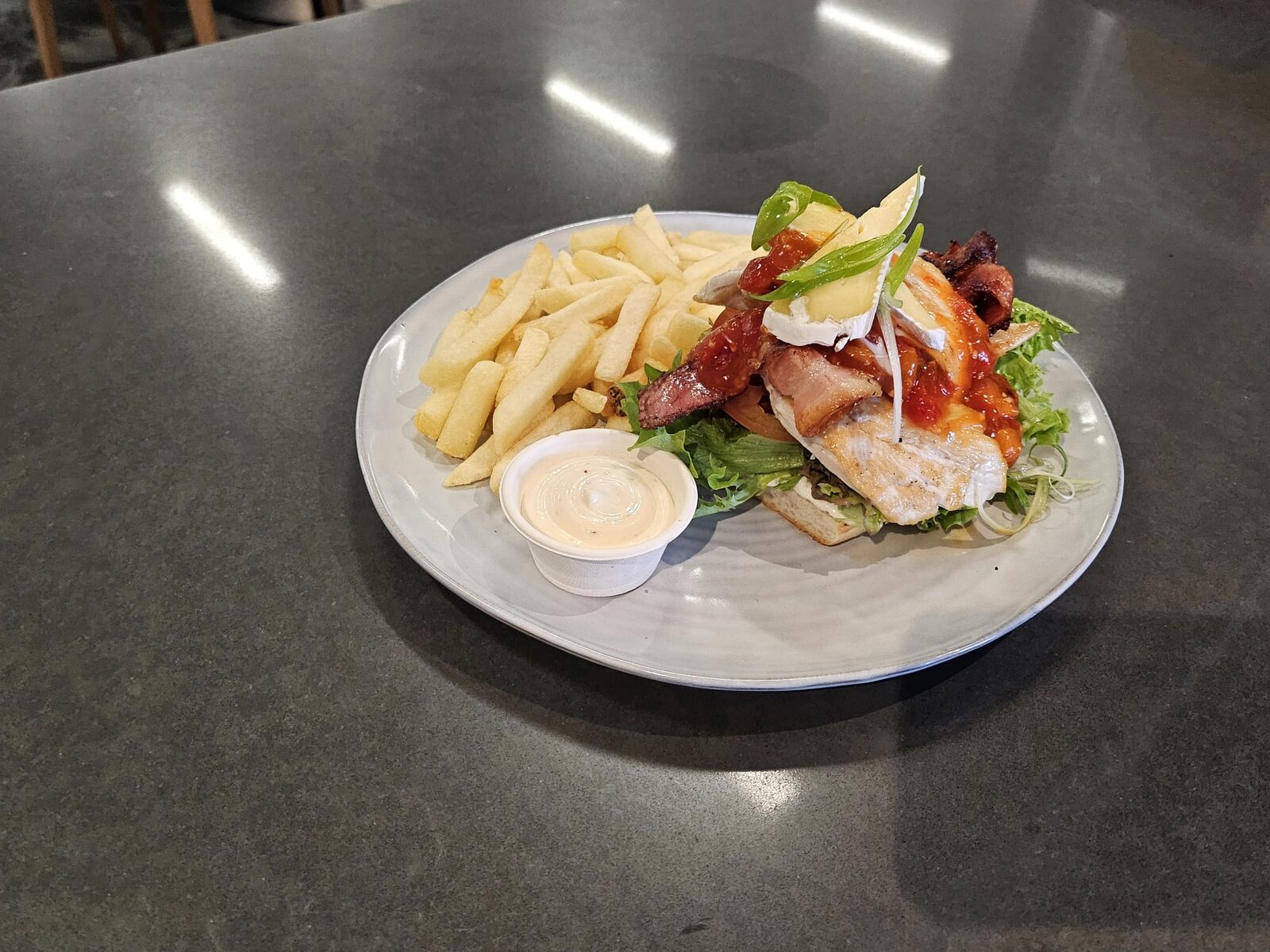 Grilled chicken and bacon stack with fries