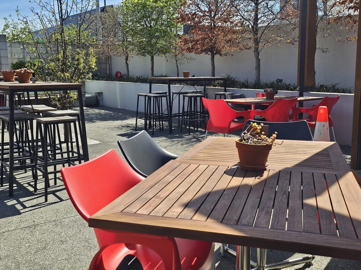 Tables on the club's sunny outdoor courtyard