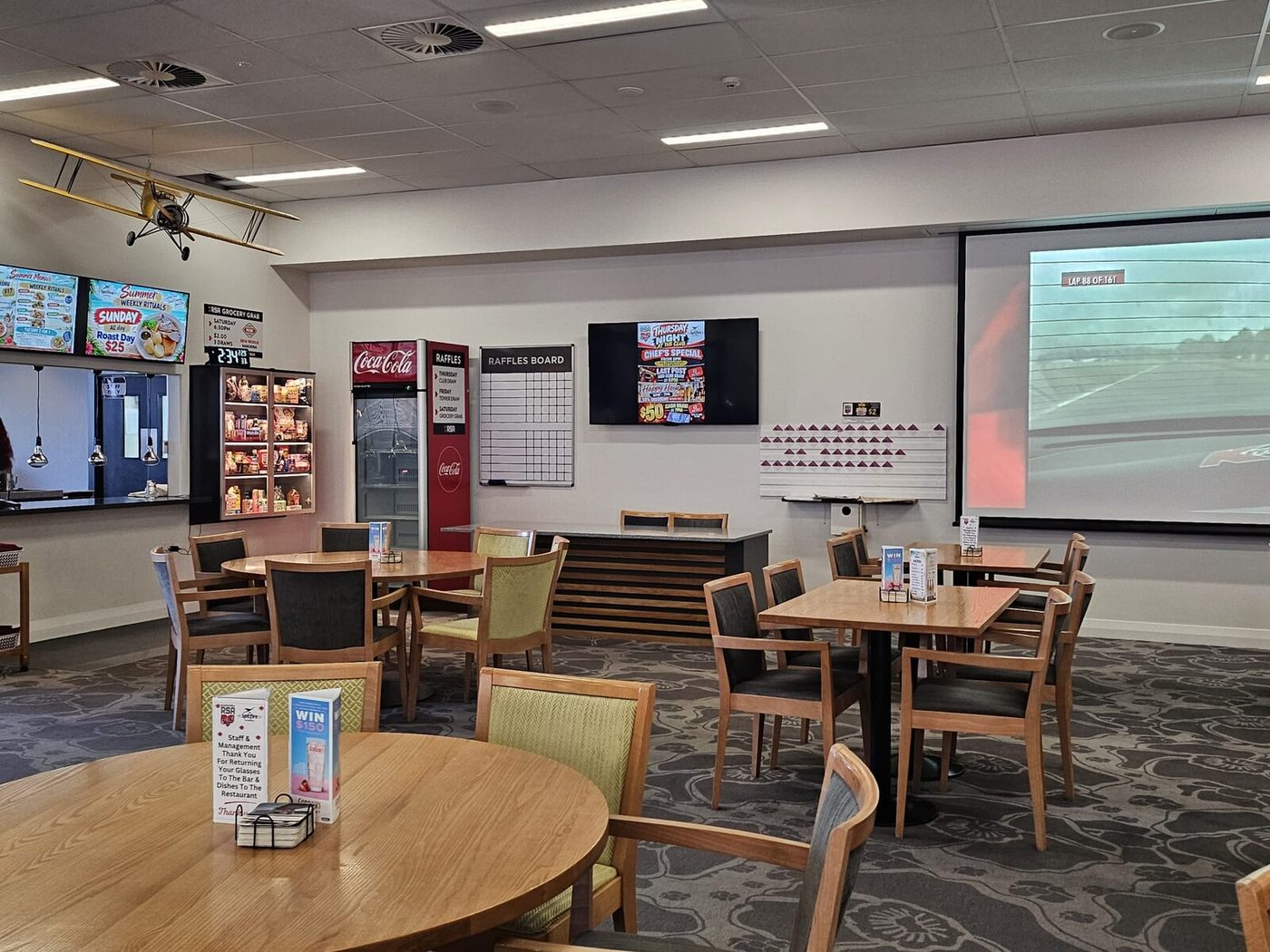 Lounge with screens, seating and a big screen for sport